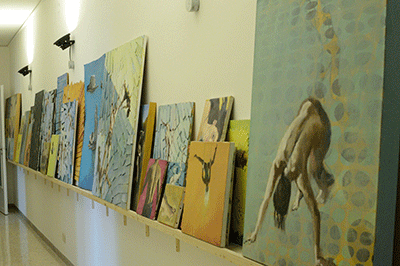 Shelf of paintings in Studio